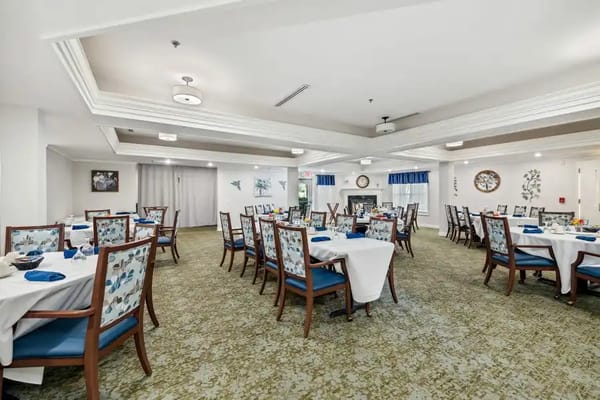 Bright and spacious dining room with tables set for meals