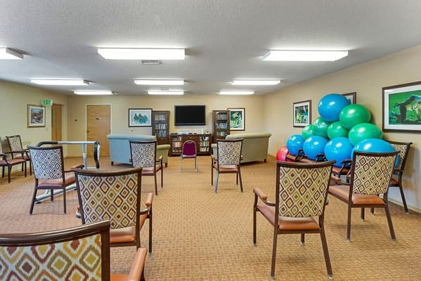 Interior view of a common area with chairs and exercise balls