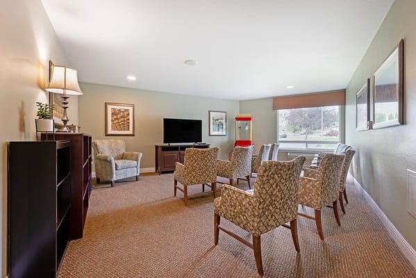 A cozy common area with seating and a TV