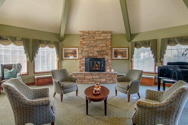 Comfortable common area with seating around a fireplace
