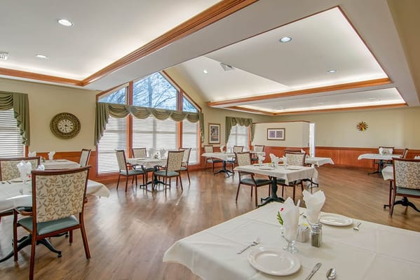 A dining room setup with tables and chairs