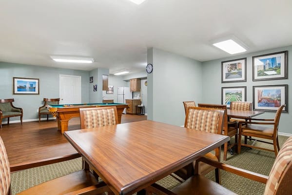 Bright common area with tables and pool table