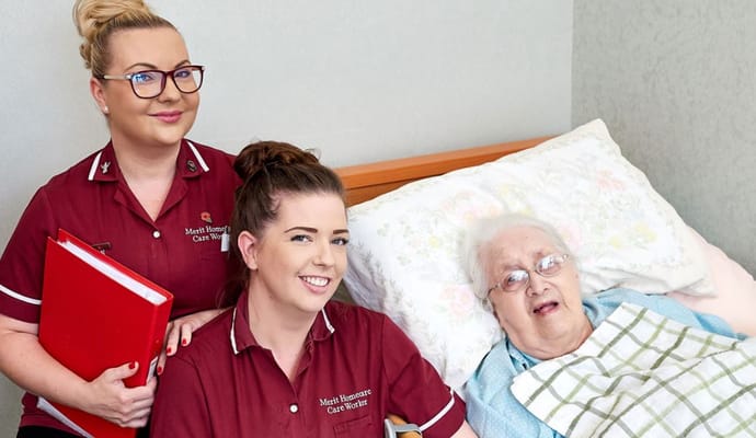 Care staff smiling with a resident in a room