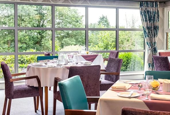 Bright dining room with tables set for a meal