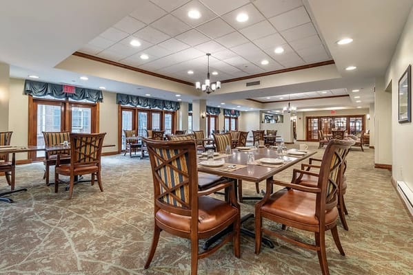 Dining room set up for meals with tables and chairs