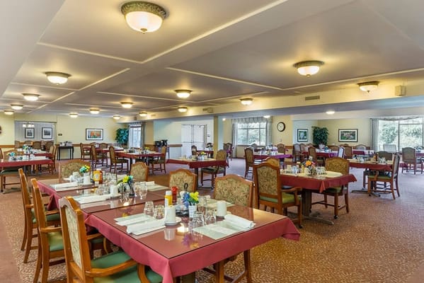 Dining room setup with tables and flowers