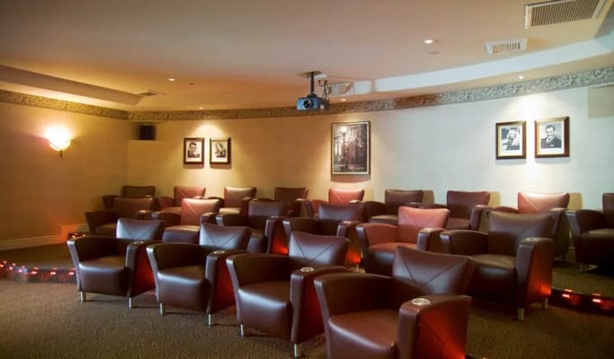 Interior view of a cozy movie room with plush seating