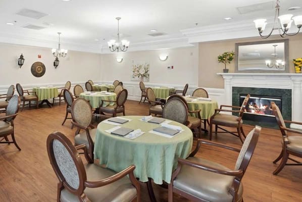 Cozy dining room with green tablecloths and a fireplace
