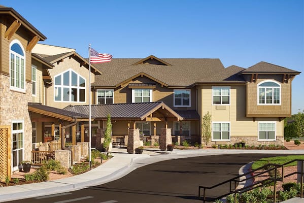 Exterior view of the assisted living facility with a flag