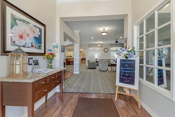 Bright lobby area with floral decor and welcome sign