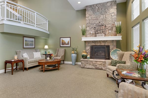 Cozy common area with comfortable seating and a stone fireplace