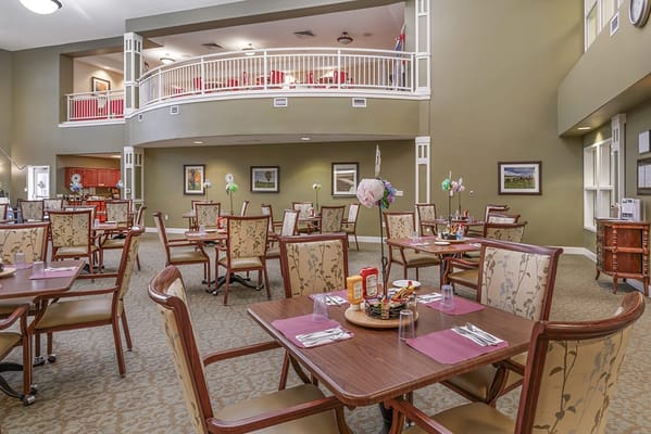 Bright dining area with tables and chairs set for meals