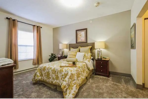 Cozy bedroom with floral bedding in a senior living space
