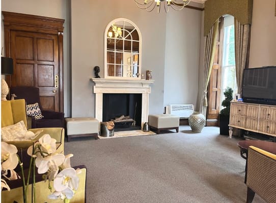 Interior of a cozy common area with a fireplace