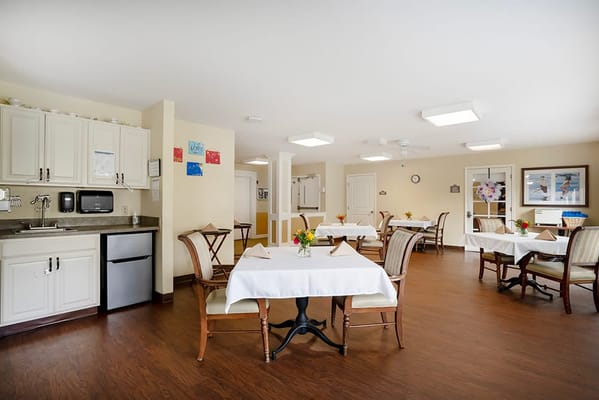 Bright dining room with tables set for residents