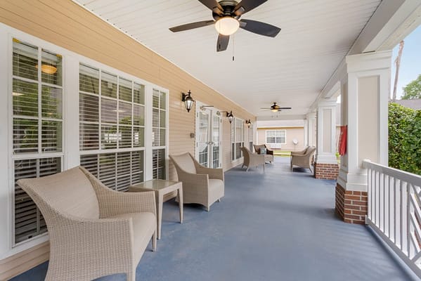 Covered porch area with seating and ceiling fans