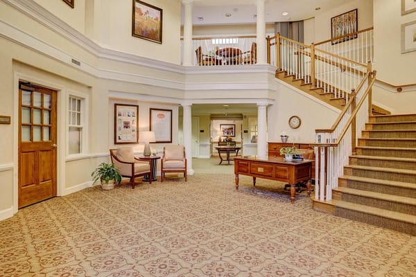 Welcoming lobby area with seating and staircase