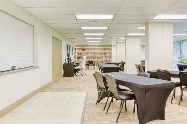 Interior of a common area with tables and bookshelves
