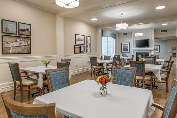 Bright dining area with neatly set tables and decor