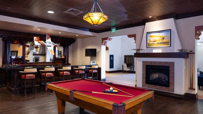 Common area with a billiards table and bar seating