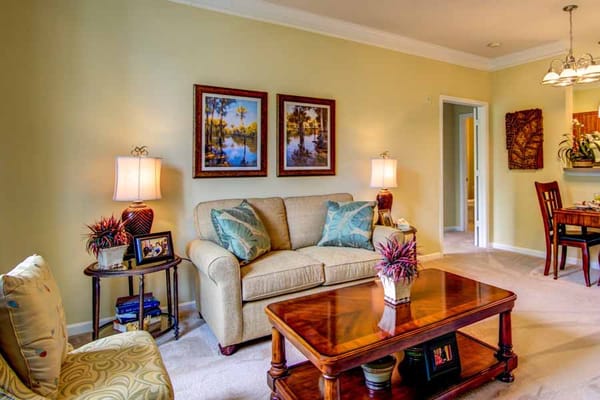 Cozy living room with beige couch, table, and artwork