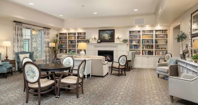 Spacious living room with seating and bookshelves