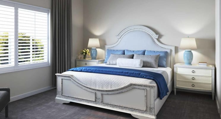 Well-decorated bedroom with a large bed and natural light from the window.