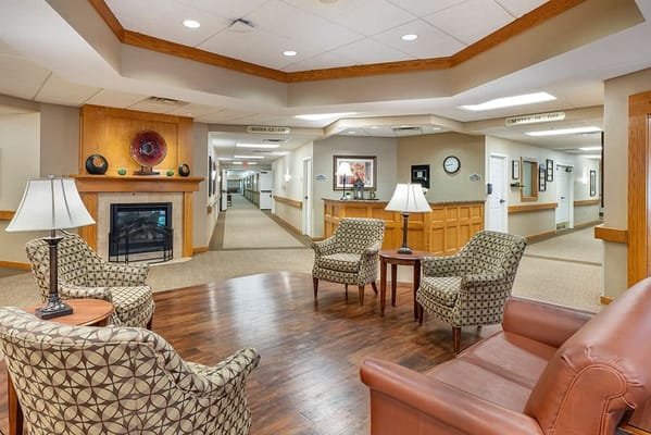 Common area with seating and fireplace in a senior facility
