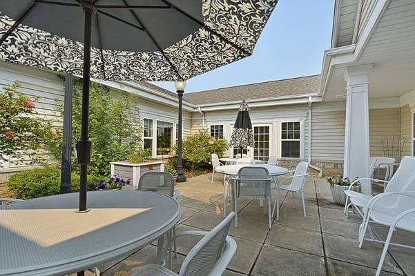 Outdoor seating area with umbrellas and gardens
