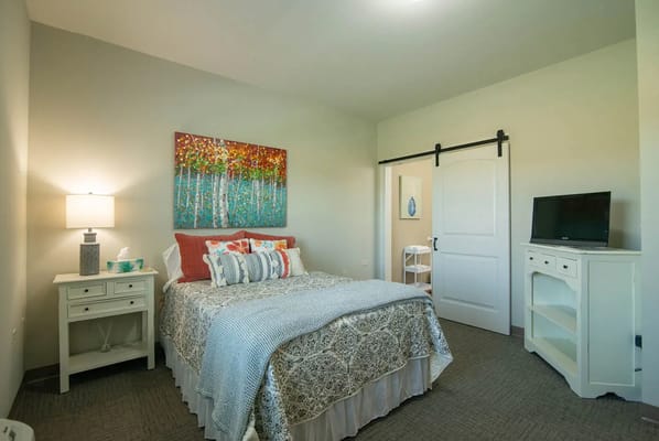 Cozy private room with a bed and artwork