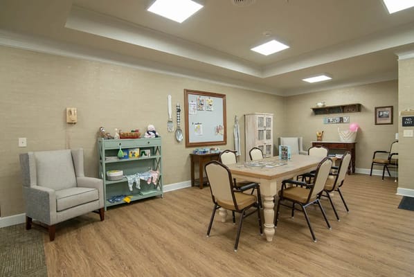 Bright common area with a large table and chairs