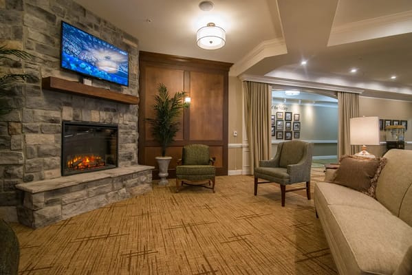 Comfortable living room with a stone fireplace and TV