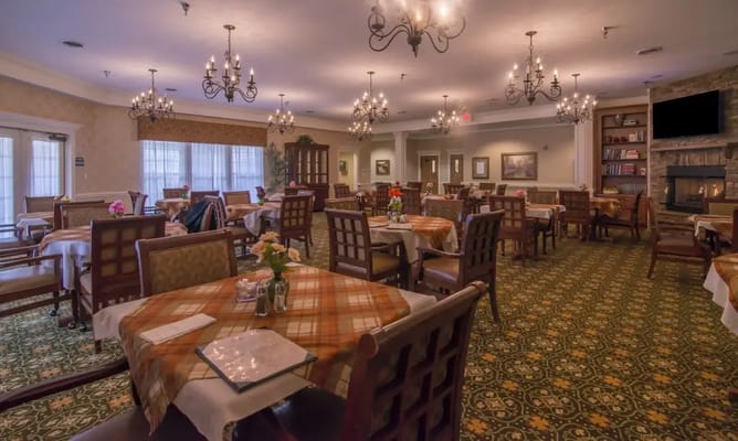 Interior view of a dining room with tables and chandeliers
