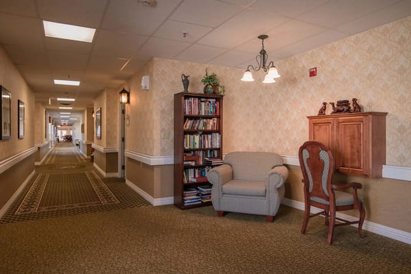 Interior hallway with seating and bookshelves