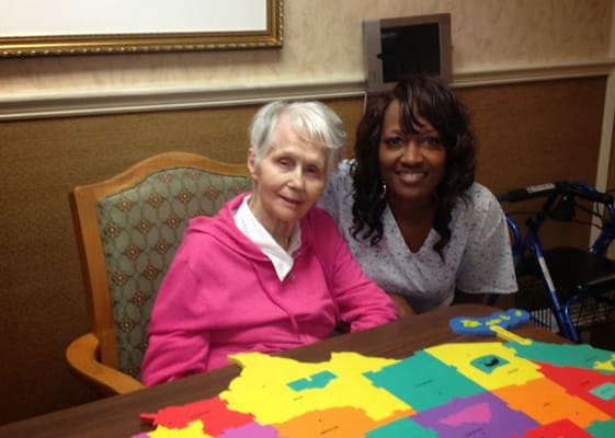 Resident and staff member enjoying a colorful activity