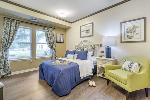 Cozy resident room with a bed and chair