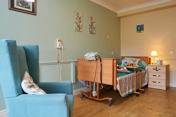 Private resident room with a bed and chair