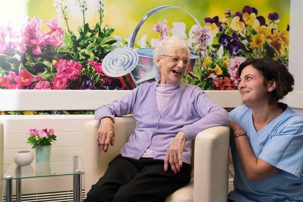 Senior resident and staff member enjoying time together