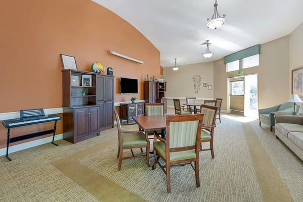 Bright common area with seating and a TV