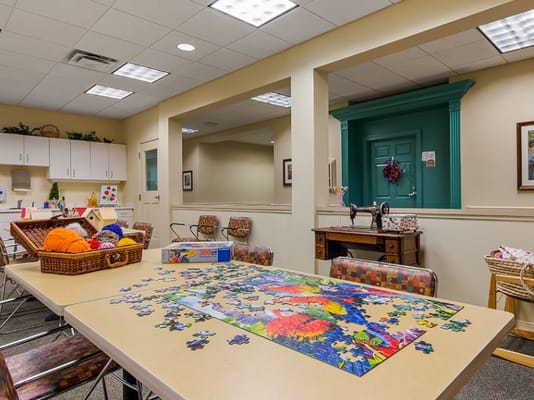 Bright activity room with a puzzle and crafts material on the table