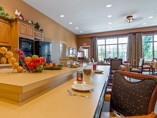 Bright kitchen and dining area with fruit basket and snacks