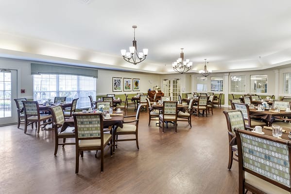 Dining room with tables and chairs set for meals