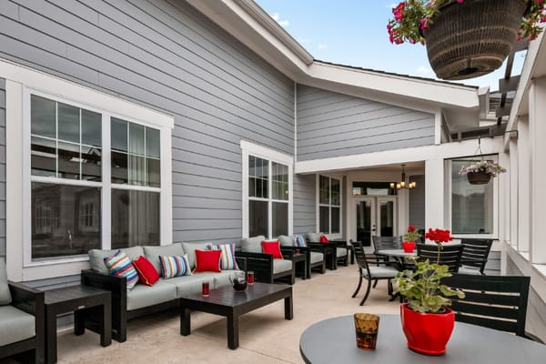Comfortable patio seating with colorful cushions at The Remington Senior Living.