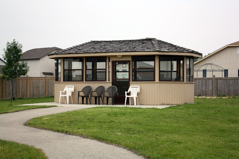 Outdoor gazebo with seating area in a grassy space