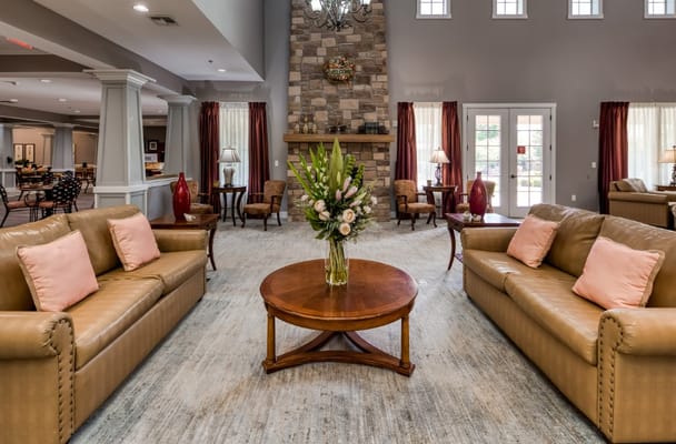 Living room with sofas, a coffee table, and a stone fireplace