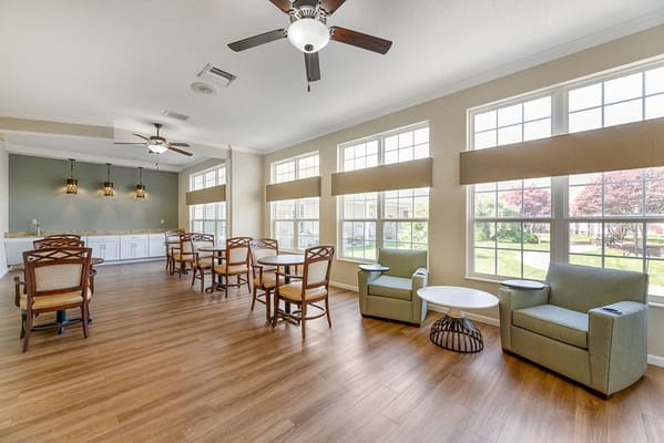 Bright common area with seating and large windows