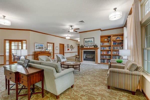 Bright interior common area with seating and a fireplace