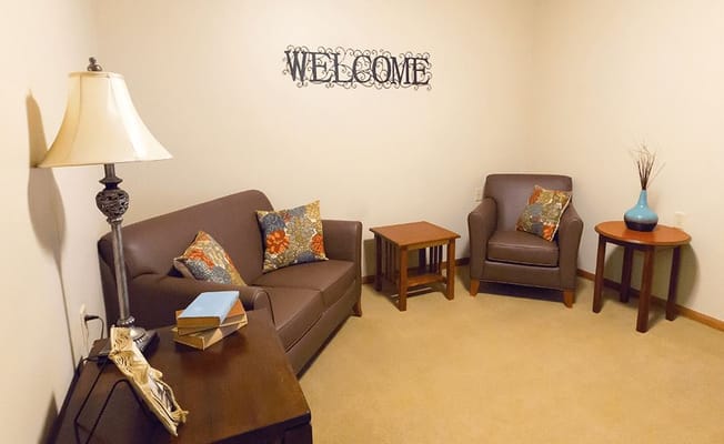 Cozy interior seating area with 'WELCOME' sign