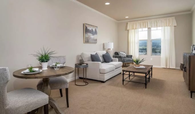 Cozy living room in a resident suite with natural light
