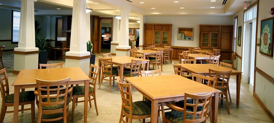 Bright dining area with wooden tables and chairs